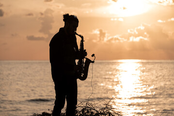 Man playing the Saxophone at sunset - 796535637
