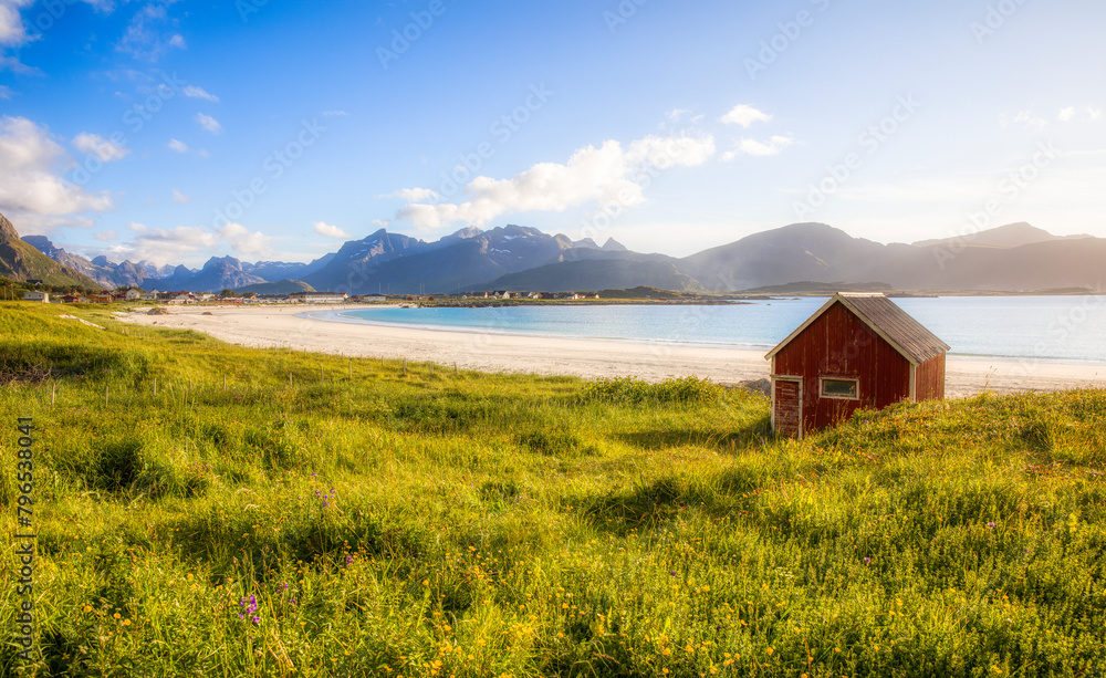 Wall mural afternoon shot of the worn hut on beautiful ramberg beach, flakstad island, lofoten, norway