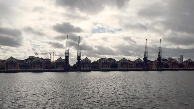 Footage of old port cranes and converted residential buildings in London.