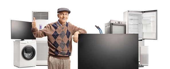Elderly man in an appliance store gesturing thumbs up