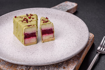 Delicious sweet cheesecake with fruits covered with icing with a wooden stick