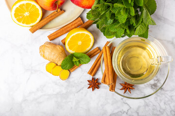 Fragrant hot tea with cinnamon stick and anise on a textured wooden background. A cup of hot tea...