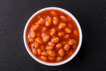 Delicious nutritious canned beans in tomato, with salt and spices