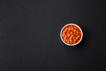 Delicious nutritious canned beans in tomato, with salt and spices