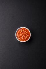 Delicious nutritious canned beans in tomato, with salt and spices