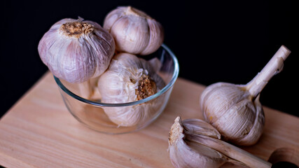 Garlic (close-up shot) on vintage wooden background.