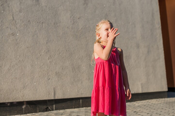 Child with hearing problem and cochlear implant plays in street, deaf kid began to hear. Hearing...