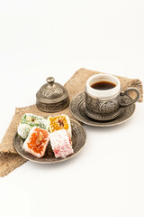 Turkish Coffee with Turkish Delight on authentic metal plate, isolated on white background