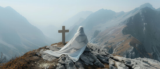 Picturesque landscape of an old wooden cross with a scarf of white fabric against a backdrop of...