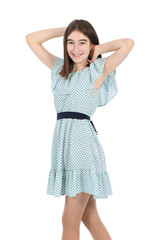 Young beautiful girl in a dress with polka dots on a white background.