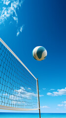 Volleyball flies over beach volleyball under blue sky and sunshine