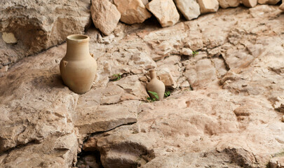 Clay beige round pot on stone background. handmade furniture in rustic style. Still life with...