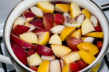 Compote of apples and strawberries. Compote with apples and strawberries. Hot drink. We prepare compote at home. View from above.