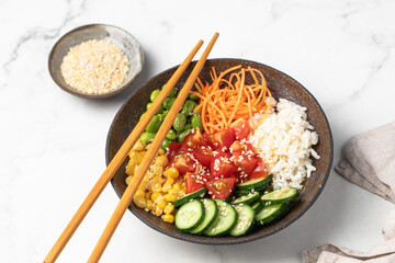 poke bowl with fresh cucumbers, carrots, edamame beans, corn, rice and sesame seeds, Bowl of...