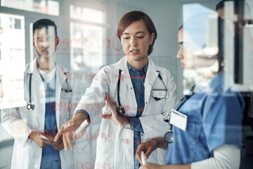Doctor, nurse and team work on glass board for medical solution, brainstorming or problem solving...