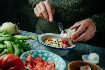preparing a salad from andalusia with broad beans