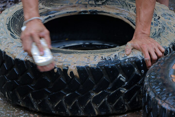 selective focus Used car tires are being cleaned by employees at a used tire shop. Makes the tires look newer