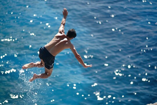 Man jumping with joy by a sea