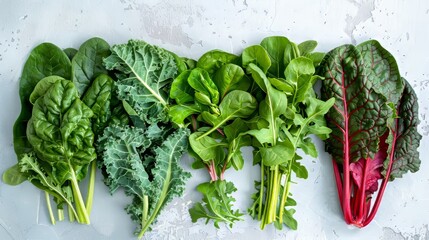 Fresh and organic spinach, kale, arugula, collard greens, and Swiss chard, photographed from above, showcasing their vibrant textures and colors, isolated