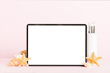 Flat lay composition with tablet and beach accessories on colored background. Tablet computer with...