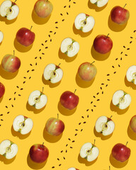 Fruit pattern on yellow background. Whole apples, halves and seeds in geometric order.
