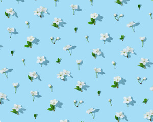 Seamless cherry blossom pattern on light blue background