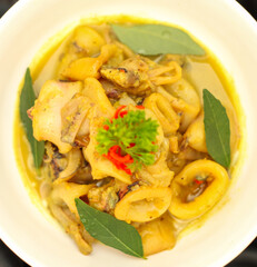 Gulai Cumi or Squid cooked yellow seasoning with coconut milk. Specialties Padang, West Sumatra Indonesia. Selective focus.
