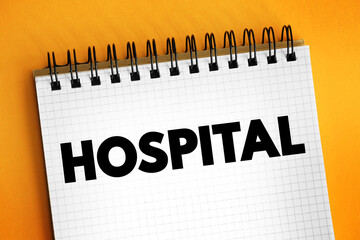 Hospital - an institution providing medical and surgical treatment and nursing care for sick or injured people, text concept on notepad - 796661222