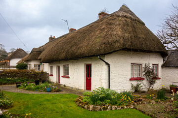 Typical Thatched Roof House. Thatched roof cottage in the picturesque village of Adare, Ireland