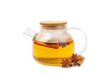 Fragrant hot tea with cinnamon stick and anise isolated on a white background. A teapot brewing hot tea with honey, lemon, mint and apples. Spicy tea with spices. Immunity tea. Health concept.