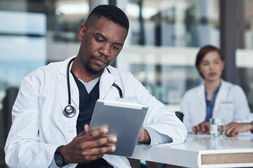 Office, black man or doctor with tablet reading report, research or checking hospital schedule....