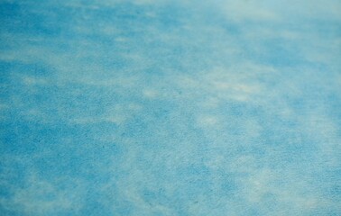 Soft light blue thin fabric paper texture isolated on copy spaced blank horizontal background.