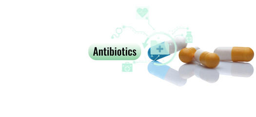 Antibiotic capsule pills on white background. Prescription drugs. Colorful capsule pills. Antibiotic drug. Pharmaceutical industry. Hospital care and health insurance service. Antibiotic drug research