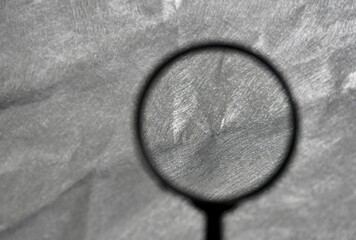 Close up silver gray fabric clothing material texture with magnifying glass background isolated on horizontal ratio with empty copy space for social media, website post, and cover prints.