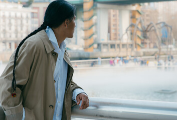 Fototapeta premium Young ecuadorian man contemplating iconic city building, copy space.