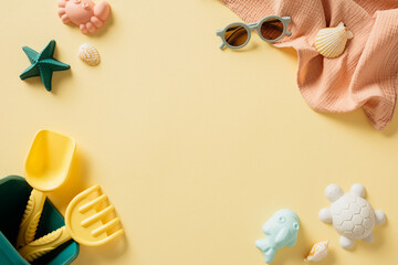Frame of beach sand toys and sunglasses on pastel beige background. Summer, vacation concept.