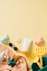 Tube of sunscreen, children's sunglasses and beach toys on beige table. Infant skin care, sun protection concept. Flat lay, top view.