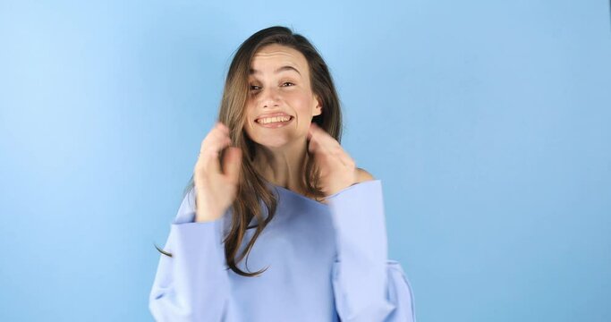 This is me? Wondered woman with brunette hair in pullover pointing herself, looking surprised shocked by personal achievements, amazed at own success isolated on blue background. Woman show wow sign.