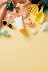 Sunscreen cream tube mockup with sand beach toys on pastel beige background. Sunscreen protect for kids concept