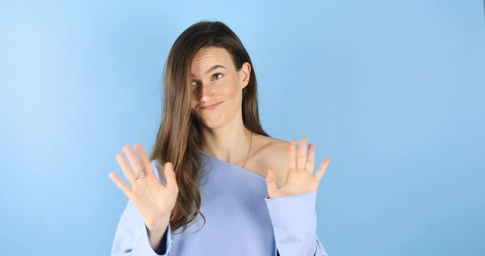 Brunette woman looking camera pointing fingers herself ask me no i do not need it. Girl point on her, waving her hands and say no isolated on blue background.