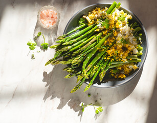 Asparagus salad Mimosa. Spring and Easter salad with grated egg, capers and aromatic dressing. Sunlight background. Healthy vegetarian balanced recipes for spring, seasonal cuisine