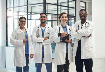 Doctors, smile and portrait in hospital standing with arms crossed for health care, wellness and...