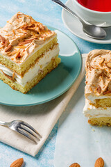 Norwegian cake. With meringue, whipped cream and almonds. Light background.
