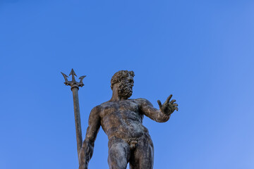 The bronze Neptune reaches towards the heavens, trident in hand, at Bologna Fountain of Neptune,...