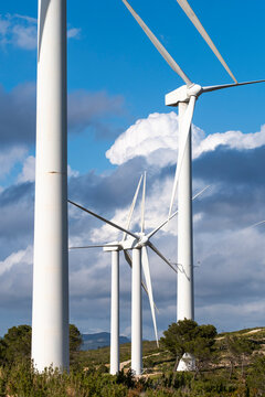 This close-up captures the grand scale of wind turbines in Tarragona, Catalonia, Spain, symbolizing the strength of green energy and the environmental commitment of the region