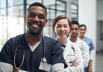 Doctors, man and arms crossed with smile, team or portrait for diversity in medical career at...