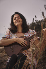 Woman playing music in the middle of the mountain