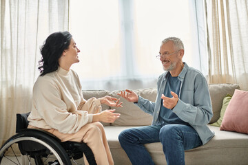 A man in a wheelchair engages in a heartfelt discussion with a disabled woman in a wheelchair in a...