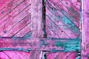 Old wooden planks with knots and nail holes on a gate as a background texture