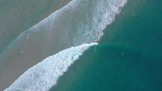 Top scene sea water with white foam on sandy beach summer. Nature travel concept. Video from drone.
